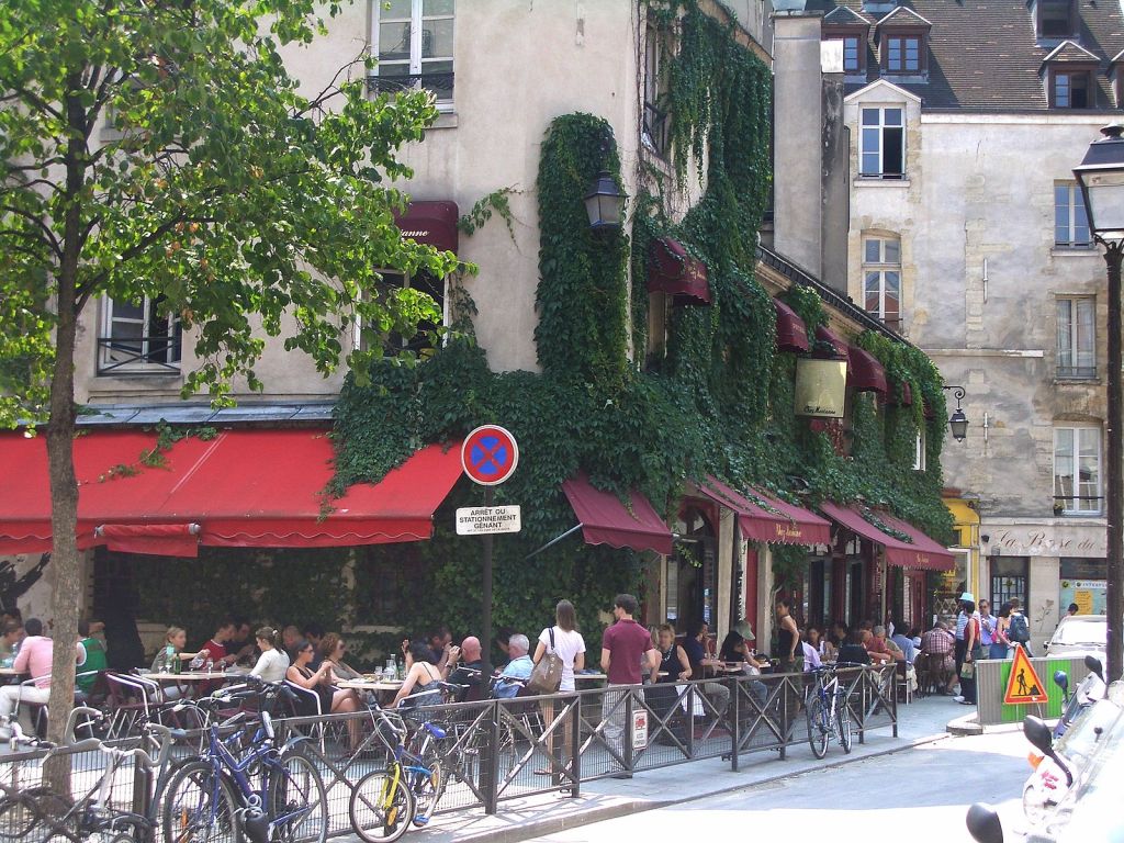 Outdoor tables under a red awning